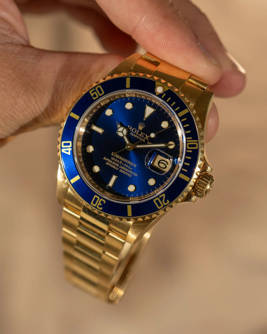 alt="Rolex Submariner 16618 – blå tavla, helguld"